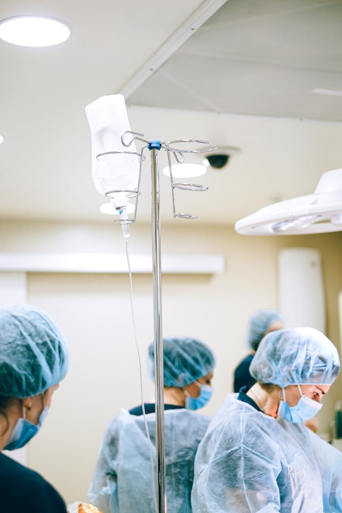 Healthcare professionals wearing protective gear in a hospital environment.