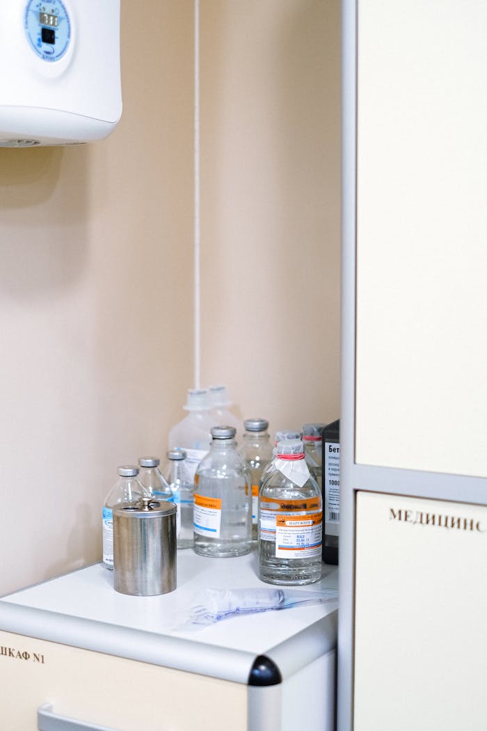 Medical bottles and supplies in a sterile clinic environment.